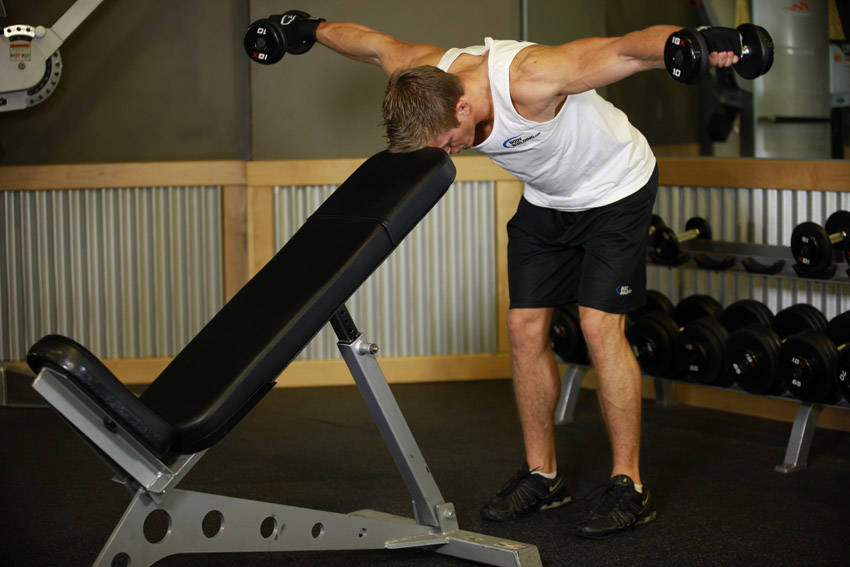 Bent Over Dumbbell Rear Delt Raise With Head On Bench - ending position