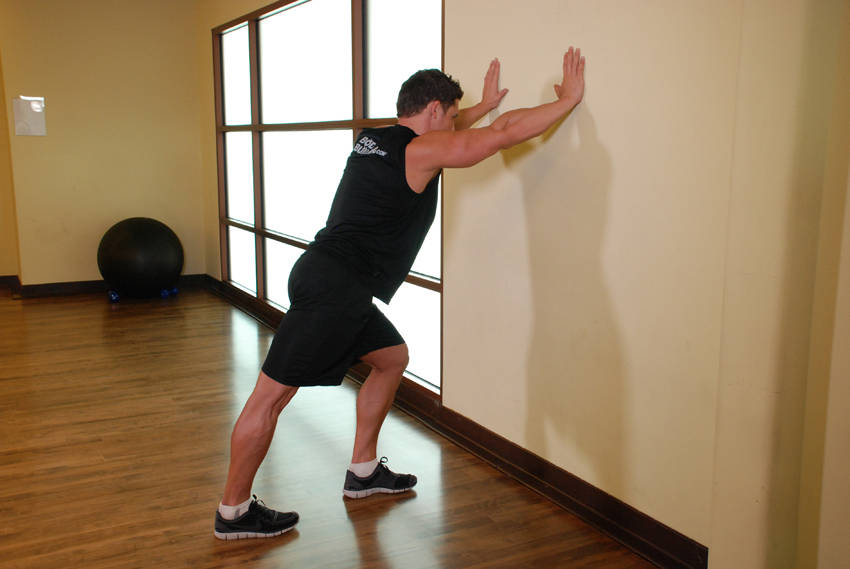 Calf Stretch Hands Against Wall - starting position