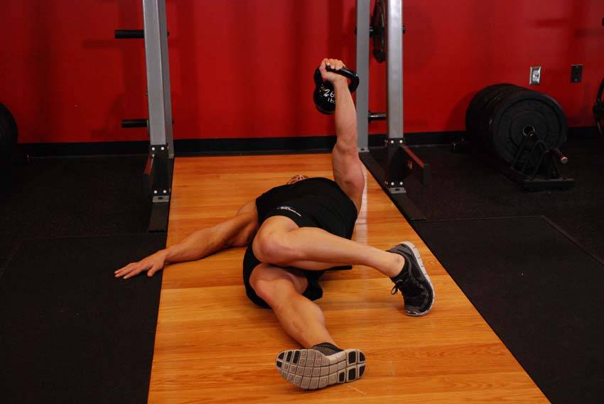 Extended Range One-Arm Kettlebell Floor Press - ending position