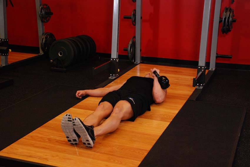 One-Arm Kettlebell Floor Press - starting position