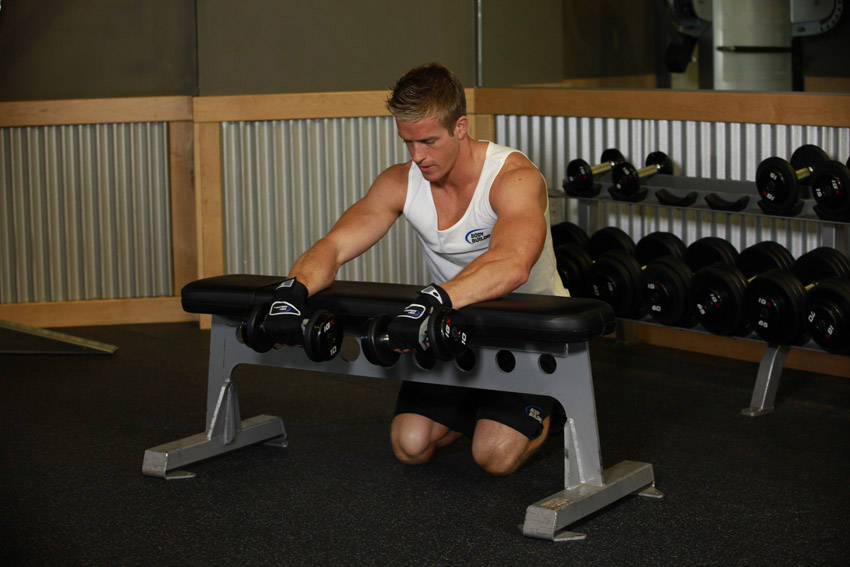 Palms-Down Dumbbell Wrist Curl Over A Bench - starting position