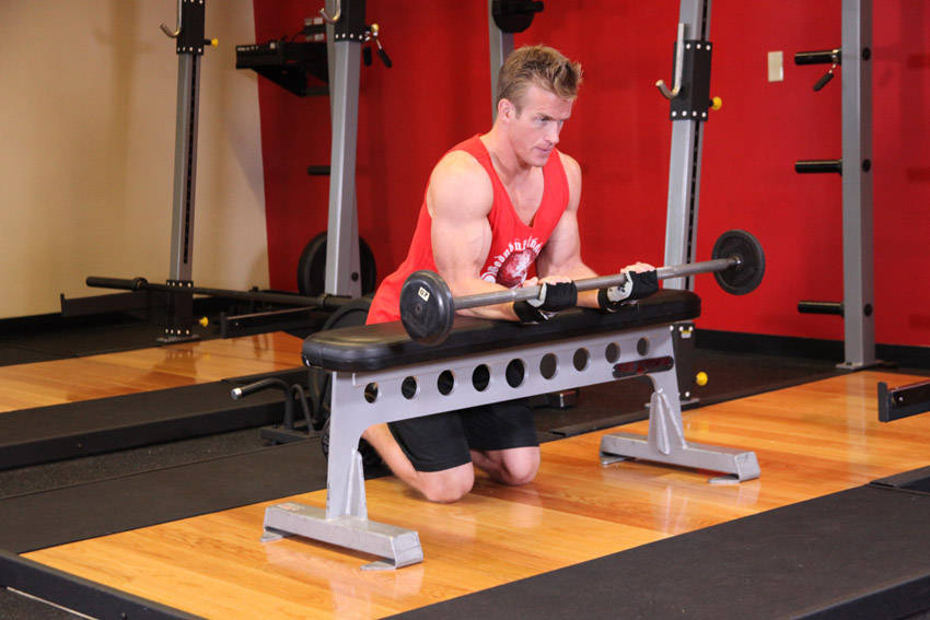 Palms-Up Barbell Wrist Curl Over A Bench - ending position