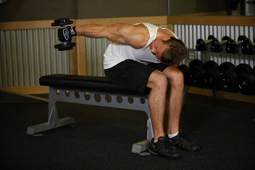 Seated Bent-Over One-Arm Dumbbell Triceps Extension - ending position