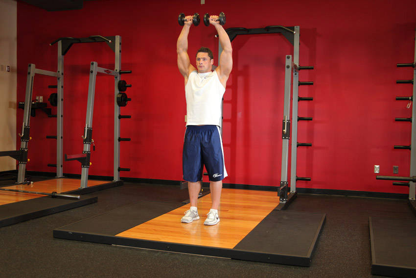 Standing Dumbbell Straight-Arm Front Delt Raise Above Head - ending position