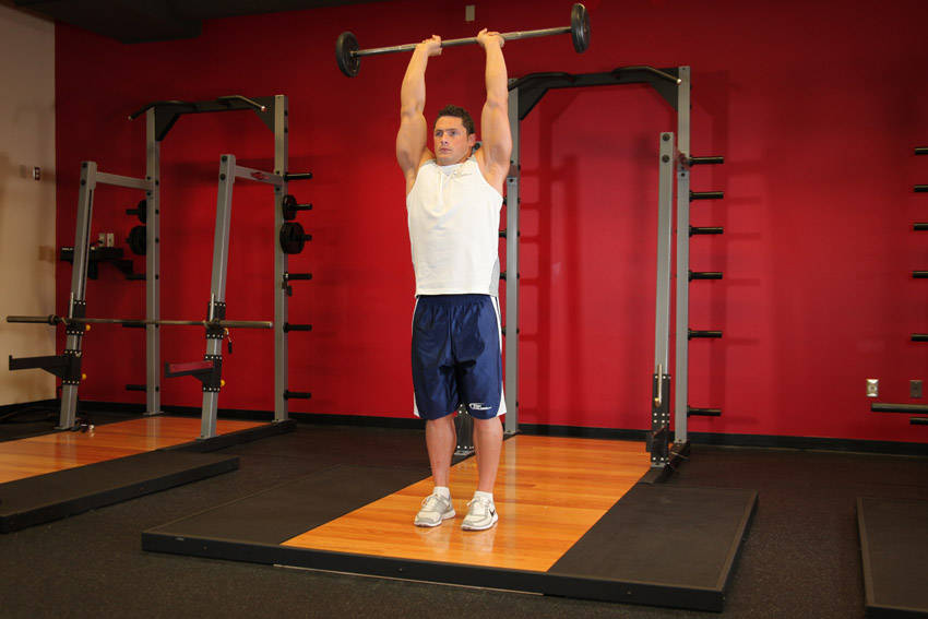 Standing Overhead Barbell Triceps Extension - ending position