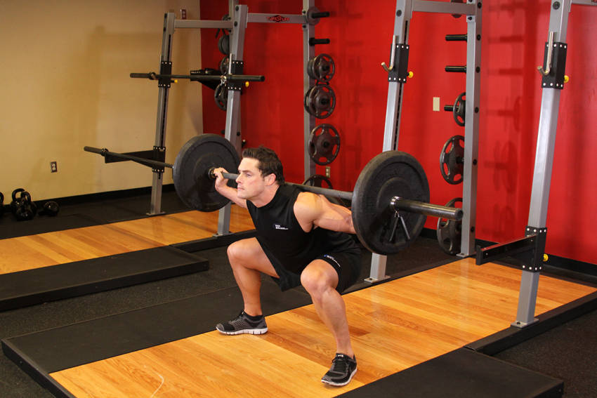 Wide Stance Barbell Squat - ending position